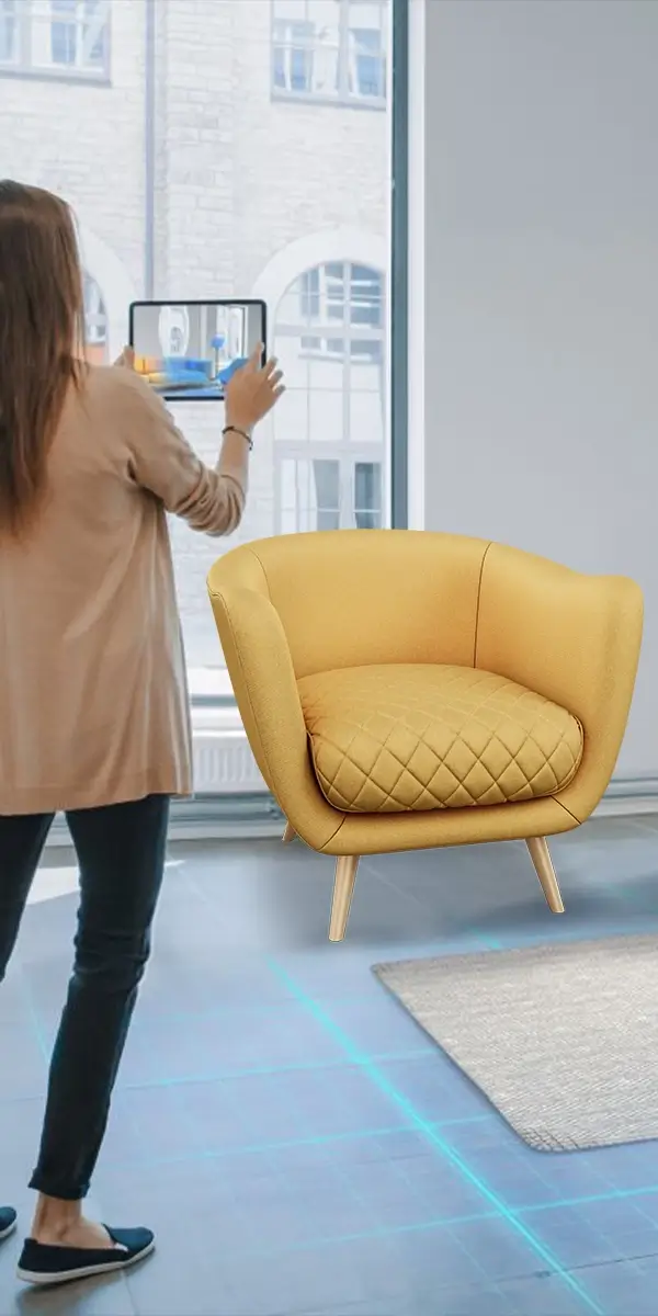 A lady is using a tablet to visualize a yellow chair in a room with augmented reality technology for shopping