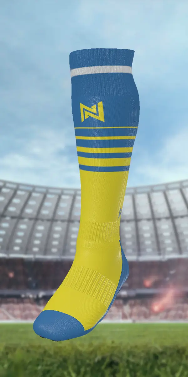 Yellow and blue soccer sock with logo, featuring multiple horizontal stripes, displayed against a blurred stadium background.